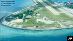 In this Aug. 22 frame grab from handout video provided by the Philippine Coast Guard, structures on the Chinese occupied Subi reef, locally called Zamora reef are seen at the disputed waters of the South China Sea. (Philippine Coast Guard via AP)