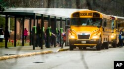 FILE - Students exit a school bus at Richneck Elementary School on Jan. 30, 2023, in Newport News, Va. The mother of a 6-year-old who shot his teacher at the school was sentenced Dec. 15, 2023, to two years in prison for felony child neglect.