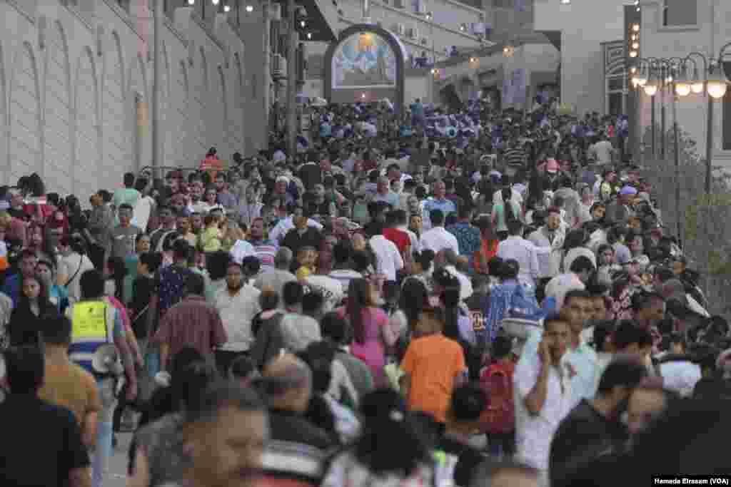 Christian worshippers and their fellow Muslim pilgrims gather inside the Virgin Mary Monastery, an ancient mountain cave turned church, where they believe the persecuted holy family once took refuge. 