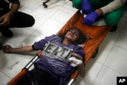 FILE - A Palestinian girl wounded in the Israeli bombardment of the Gaza Strip receives treatment at the Nasser hospital in Khan Younis, southern Gaza Strip, Jan. 2, 2024.