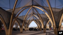 Security forces stand guard outside a convention center hosting the IMF and World Bank annual meetings, in Marrakech, Morocco, Oct. 8, 2023. 