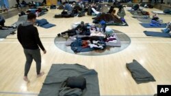 FILE - Migrants rest at a shelter in Denver, Colorado, Jan. 6, 2023. In late 2022, Venezuelans crossing into Texas from Mexico found that Denver in the U.S. state of Colorado was a cheaper bus ride from the border city of El Paso than many of the better-known cities in the U.S.