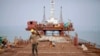 FILE - Construction of new port at the Kaladan River in Sittwe, Myanmar, May 19, 2012. The giant arms of a half-built wharf enfold the estuarine mud with steel and concrete.