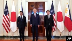 President Joe Biden, center, Philippine President Ferdinand Marcos Jr., left, and Japanese Prime Minister Fumio Kishida pose before a trilateral meeting in the East Room of the White House in Washington, April 11, 2024.