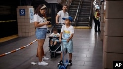 FILE - Migrant Darwin Salinas travels with wife Kimberly Carchipulla and sons Damien, 6, and Derek, 1, June 16, 2024, Jersey City, NJ.