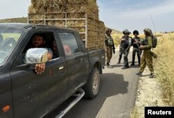 FILE - Israeli troops take position following clashes near Ramallah in the Israeli-occupied West Bank, May 26, 2023.