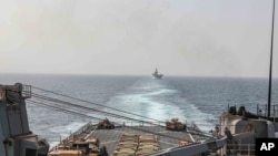 FILE — In this image provided by the U.S. Navy, the amphibious dock landing ship USS Carter Hall and amphibious assault ship USS Bataan transit the Bab al-Mandeb strait, Aug. 9, 2023. 