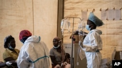 FILE - Health workers treat cholera patients at the Bwaila Hospital in Lilongwe central Malawi, Jan. 11, 2023. South Africa reported its first cholera death in February, after the virus arrived in the country from Malawi.
