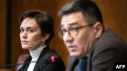 Evgenia Kara-Murza (left), wife of Kremlin critic Vladimir Kara-Murza looks on next to Sergei Davidis, head of the political prisoners support program at the Memorial human rights center, during a press conference in Geneva on March 25, 2024.