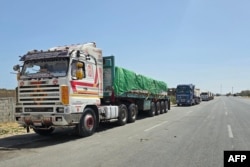 Egyptian trucks carrying humanitarian aid bound for the Gaza Strip wait near the Rafah border crossing on the Egyptian side, May 26, 2024