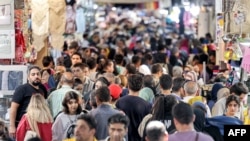 FILE - People walk at the Grand Bazaar in Tehran on Sept, 5, 2023. A year after the death of Mahsa Amini sparked unrest across Iran, the issue of the hijab remains a sore spot.