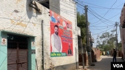 An election poster in Mankrola village. (Anjana Pasricha/VOA)