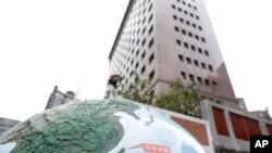 A globe is placed outside the Diplomatic Quarter building, marking the park next to the building, with areas for Taiwan and China in Taipei, Jan. 15, 2024.
