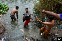 Migrants cross the Rio Grande to the U.S. side, from Matamoros, Mexico, Thursday, May 11, 2023. Migrants rushed across the Mexico border Thursday in hopes of entering the U.S. in the final hours before pandemic-related asylum restrictions are lifted. (AP Photo/Fernando Llano)