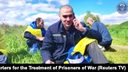 Ukrainian POW on phone at undisclosed location after being released from Russia, May 6, 2023.