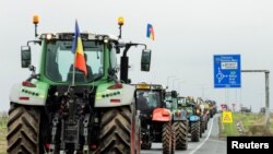 Romanian farmers line up their tractors en route to Nadlac Customs while protesting over the price of grains, in Remetea Mare, Timis county, Romania, April 7, 2023. (Inquam Photos/Cornel Putan via Reuters)