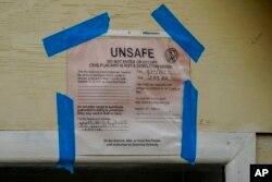 A placard marking the Waiola Church unsafe to enter is pictured, Dec. 7, 2023, in Lahaina, Hawaii.