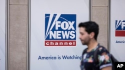 A person walks past the Fox News Headquarters in New York, April. 12, 2023. Dominion Voting Systems' defamation lawsuit against Fox News for airing bogus allegations of fraud in the 2020 election is set to begin trial on Monday, April 17, 2023, in Delaware.