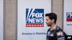 A person walks past the Fox News Headquarters in New York, April. 12, 2023. 
