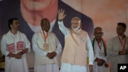 Indian Prime Minister Narendra Modi waves to the crowd as he arrives at an election campaign rally in Meerut, India, March 31, 2024.
