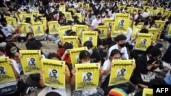 FILE - Student protesters hold posters of disappeared rights activist Wanchalearm Satsaksit at an anti-government rally at Thammasat University in Pathum Thani, north of Bangkok on Aug. 10, 2020.