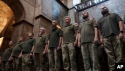 Ukrainian military chaplains attend a graduation ceremony at the Saint Sophia Cathedral in Kyiv, Ukraine, June 23, 2023.