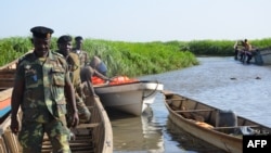 FILE - Cameroonian soldiers arrive in Darak as they patrol Lake Chad, March 1, 2013. At least 12 people have been killed in Darak in attacks by Boko Haram militants since Tuesday, authorities say.