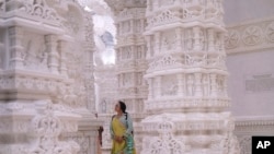 A woman admires the intricate architecture of the BAPS Swaminarayan Akshardham, the largest Hindu temple outside India in the modern era, Oct. 4, 2023, in Robbinsville, NJ.