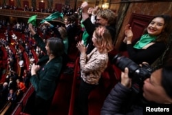 MPs and senators react after a vote to anchor the right to abortion in the country's constitution in Versailles, southwestern of Paris, France, March 4, 2024.