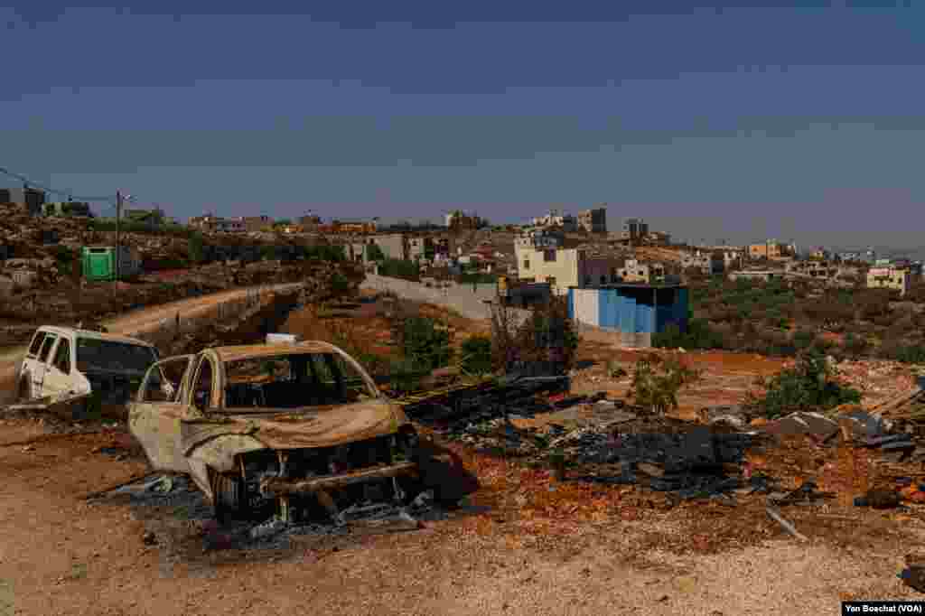 Burned cars remain where four Palestinians were killed in an attack by Jewish settlers in the small town of Qusra, Oct. 24, 2023.