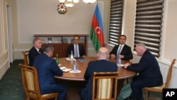 Representatives of the Armenian community of Nagorno-Karabakh, Azerbaijan's government and a representative of the Russian peacekeeping contingent attend the talks in the Azerbaijani city of Yevlakh, Azerbaijan, Sept. 21, 2023.