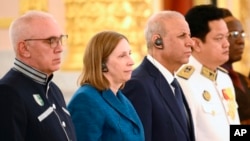 From left, Alkhas Kvitsinia of Abkhazia, Lynne Tracy of the U.S., Qahtan Taha Khalaf al-Janabi of Iraq, Pichkhun Panya of Cambodia and others listen during a ceremony for new ambassadors to Russia, in Moscow, April 5, 2023. (Kremlin pool photo via AP)