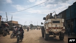 FILE - United Nations South African peacekeepers patrol a street in Oicha where an attack took place in a nearby village the day before, Jan. 29, 2020. 