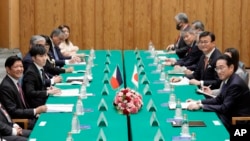 FILE - Philippines President Ferdinand Marcos Jr., left, and Japan's Prime Minister Fumio Kishida, right, confer at the prime minister's Tokyo residence, Dec. 17, 2023. Japan’s siding with the Philippines and the U.S. in security matters has strained Sino-Japanese relations.