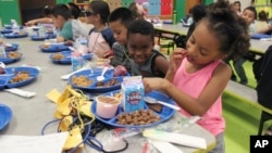 Students eat lunch in the cafeteria at Lowell Elementary School in Albuquerque, New Mexico, Aug. 22, 2023.