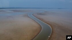 FILE - A boat travels through a section of the Amazon River impacted by drought in the state of Amazonas, near Manacapuru, Brazil, Sept. 27, 2023.