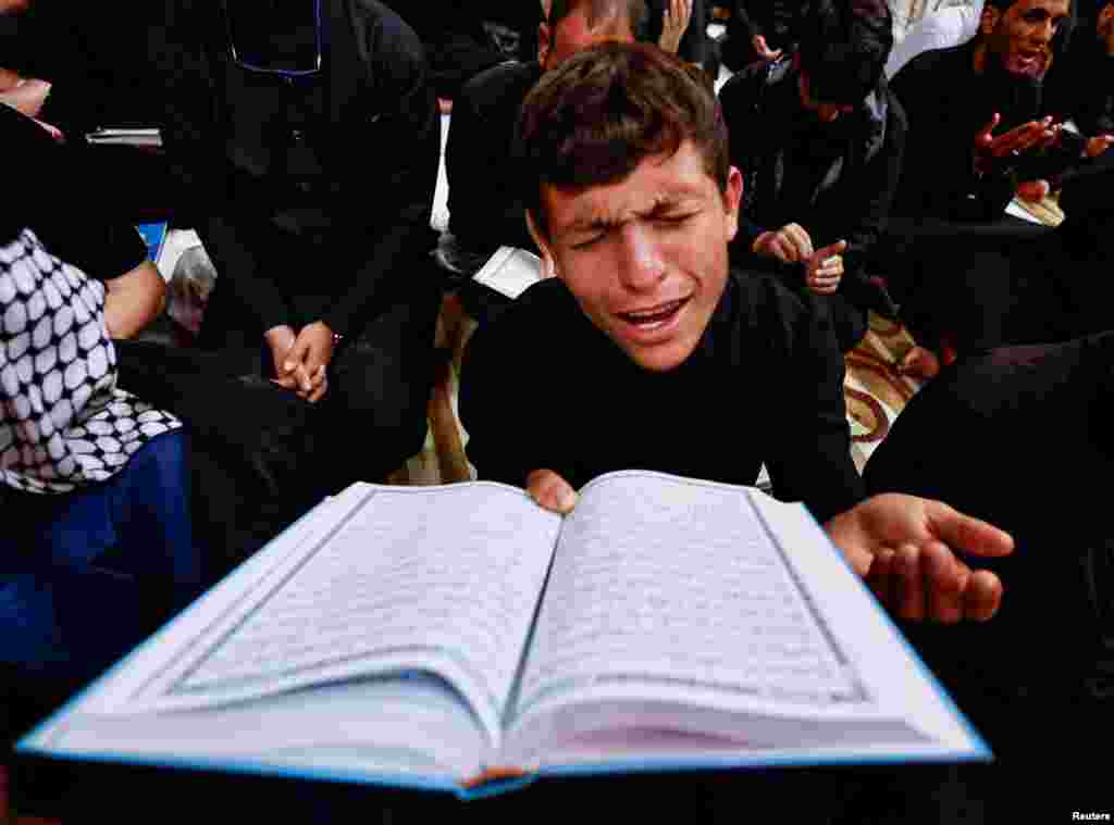 A Shiite worshiper prays while marking the death anniversary of Imam Ali at his shrine in the holy city of Najaf, Iraq, April 11, 2023.