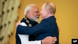 FILE - Russian President Vladimir Putin, right, and Indian Prime Minister Narendra Modi embrace after Putin awarded Modi with the Order of St. Andrew the Apostle, at the Kremlin in Moscow, July 9, 2024.