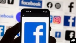 FILE - The Facebook logo is seen on a cell phone, on Oct. 14, 2022. On April 8, 2024, the Committee to Protect Journalists urged the Taliban not to move ahead with its plan to restrict access to Facebook in Afghanistan. 