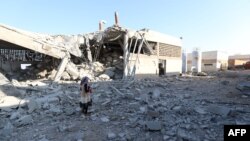 A girl stands amidst debris after Russian airstrikes hit an abandoned water pumping station in Syria's rebel-held northwest, on August 23, 2023. 