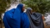 FILE - Two women walk near the Ethiopian border crossing on the outskirts of Dollow, Somalia, Sept. 20, 2022. 
