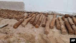 This photo released by the Cambodia Mine Action Center, CMAC, shows unexploded ordnance at Queen Kosamak High School in Kratie Province, northeastern of Phnom Penh, Cambodia, Sunday, Aug. 13, 2023. (Cambodia Mine Action Center via AP)