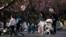 Parents push strollers with their babies in a park in Shanghai, China, April 2, 2023.