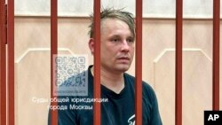 In this photo released by Basmanny District Court press service, Russian journalist Konstantin Gabov attends a hearing at a court in Moscow, April 27, 2024, after his arrest on extremism charges, which he denied. 