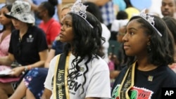 Miss Juneteenth Arizona Shaundrea Norman, 17, left, and Teen Miss Juneteenth Arizona Kendall McCollun, 15, attend an annual Juneteenth celebration at Eastlake Park in Phoenix, June 18, 2022. 