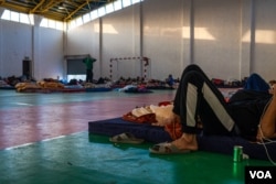 Families trapped inside Gaza report constant bombing and fear via phone and text message to these men who cannot go home to help them, pictured on Oct. 13, 2023, in Ramallah, West Bank. (Yan Boechat/VOA)