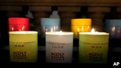 FILE - Candles light at 'Our Lady of Athletes' chapel inside the Madeleine church, Thursday, May 30, 2024 in Paris.