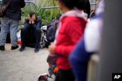 People waiting to apply for asylum camp near the pedestrian entrance to the San Isidro Port of Entry, linking Tijuana, Mexico with San Diego, June 1, 2023, in Tijuana, Mexico.