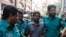 Police escort reporter Shamsuzzaman Shams (C), who has been arrested and charged under the Digital Security Act, to a court in Dhaka, Bangladesh, March 30, 2023.