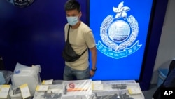 FILE - Confiscated evidence is displayed during a news conference as nine people were arrested over the alleged plot to plant bombs around Hong Kong, at the police headquarters in Hong Kong on July 6, 2021.